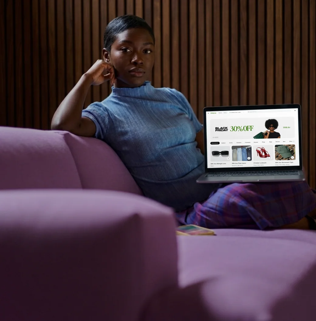 A business owner relaxing while her Daash online store runs on a laptop